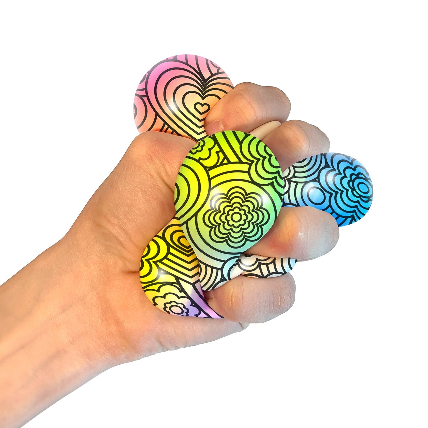 A hand squeezing a Press-Doh. The colorful doh is visible through the white and black designs of the exterior.