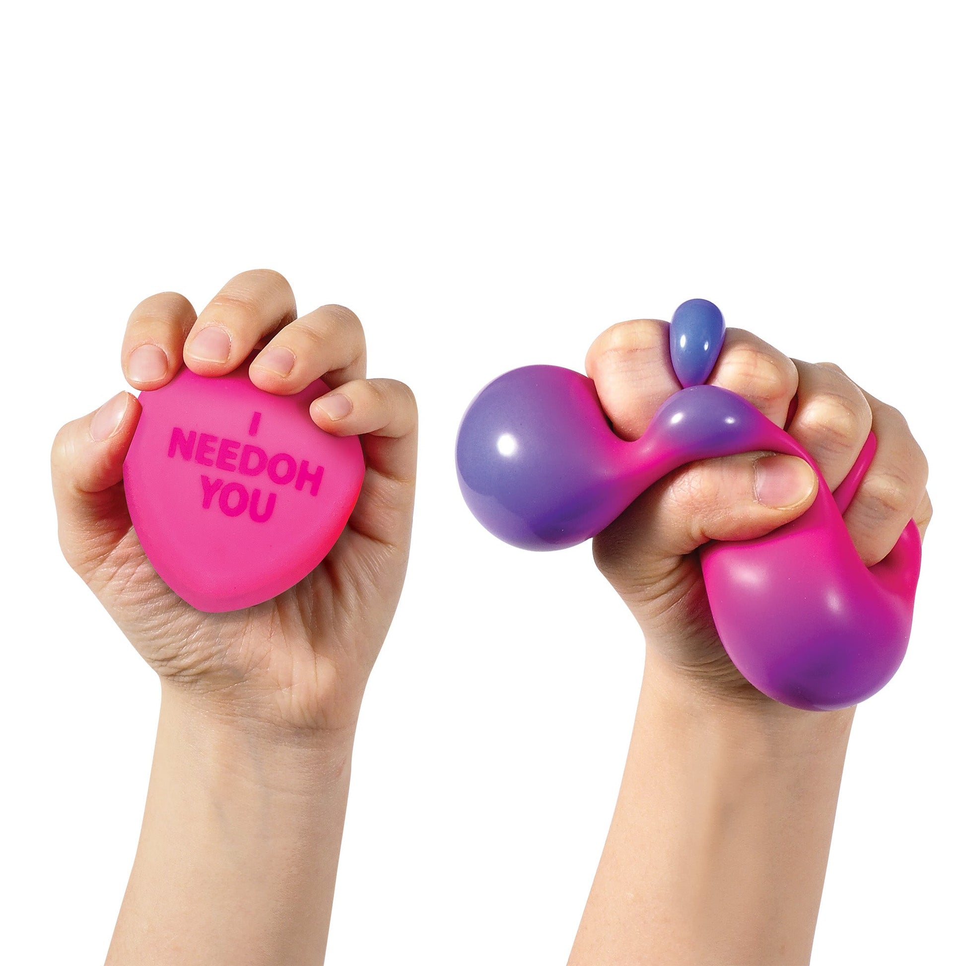 Two hands squeezing colorful sensory hearts. The left hand holds a pink heart-shaped sensory toy with the words "I YOU" printed on it. The right hand is squeezing a fluid, malleable sensory toy that transitions from pink to purple.