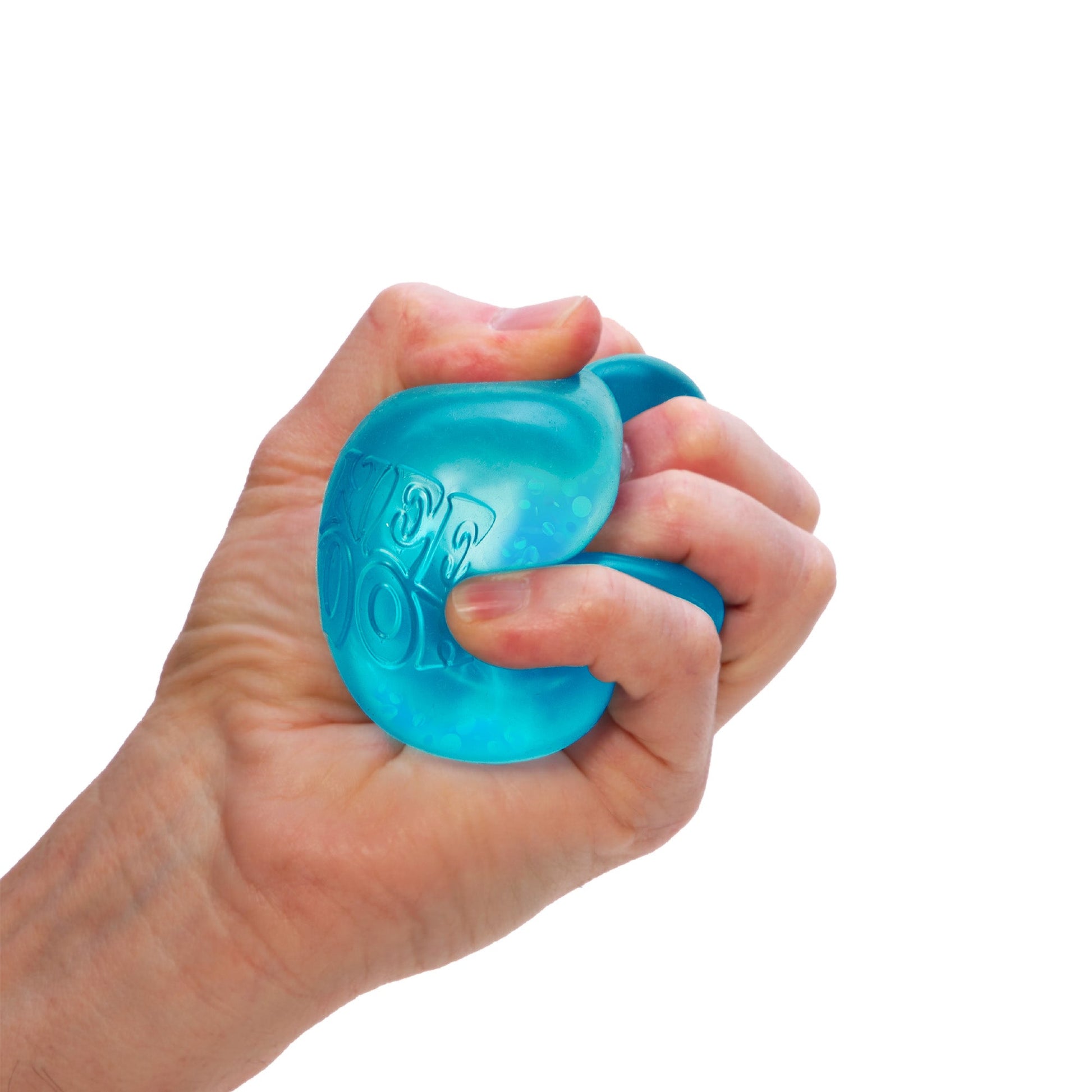 A hand is squeezing a blue sensory toy against a white background. The toy has some texture and appears slightly translucent. The fingers are wrapped tightly around it, indicating a firm grip.