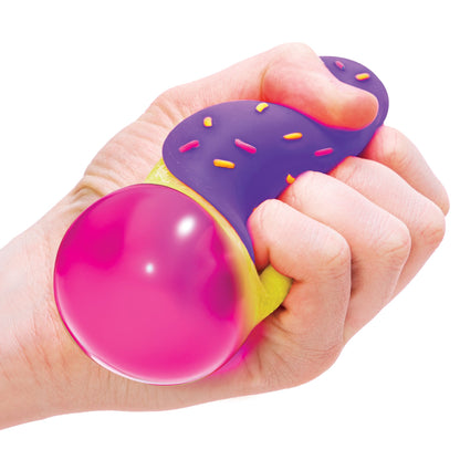 Jelly Donuts - Yellow Dohnut with Purple Frosting Being Squeezed in Hand